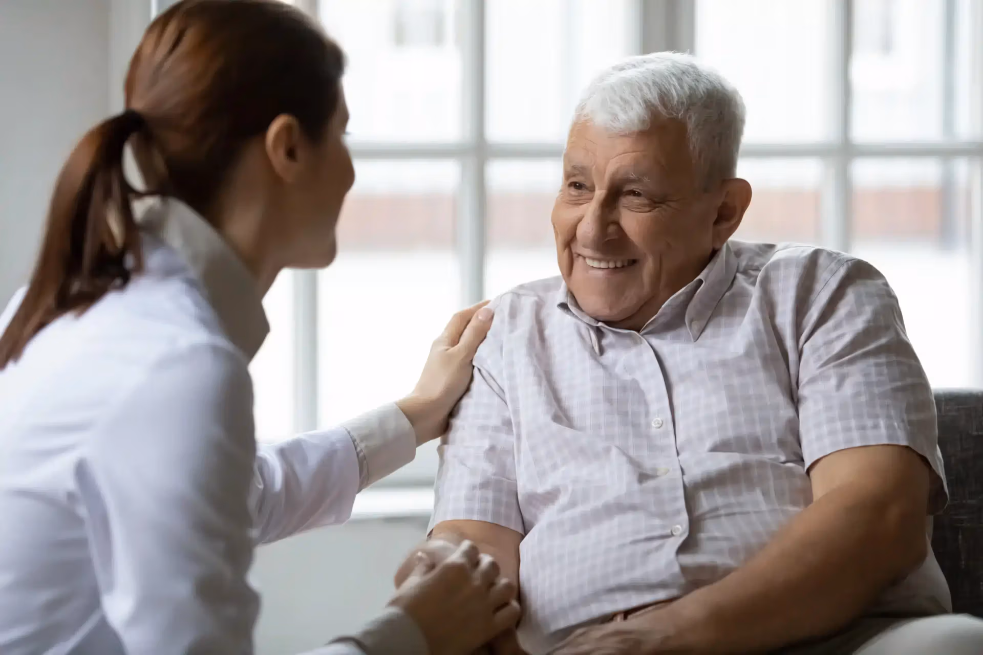 Speech therapist working one-on-one with a senior resident