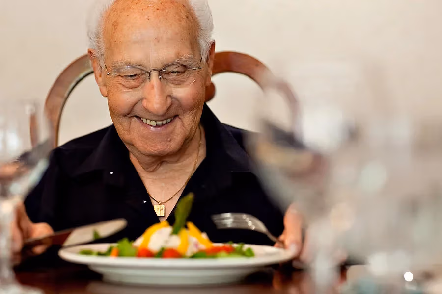 A resident savoring a beautifully prepared meal