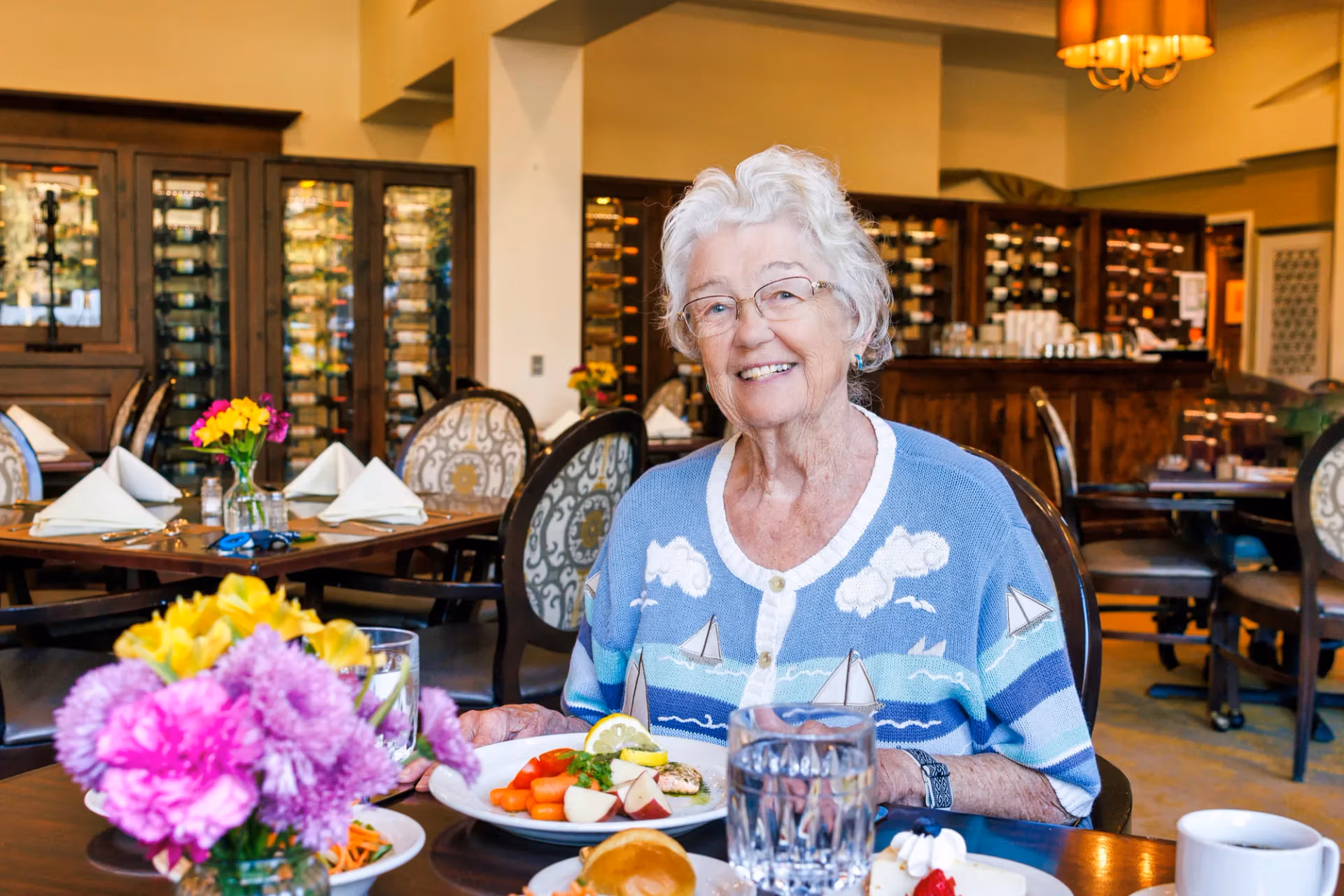 A resident enjoying breakfast at a beautifully set table.