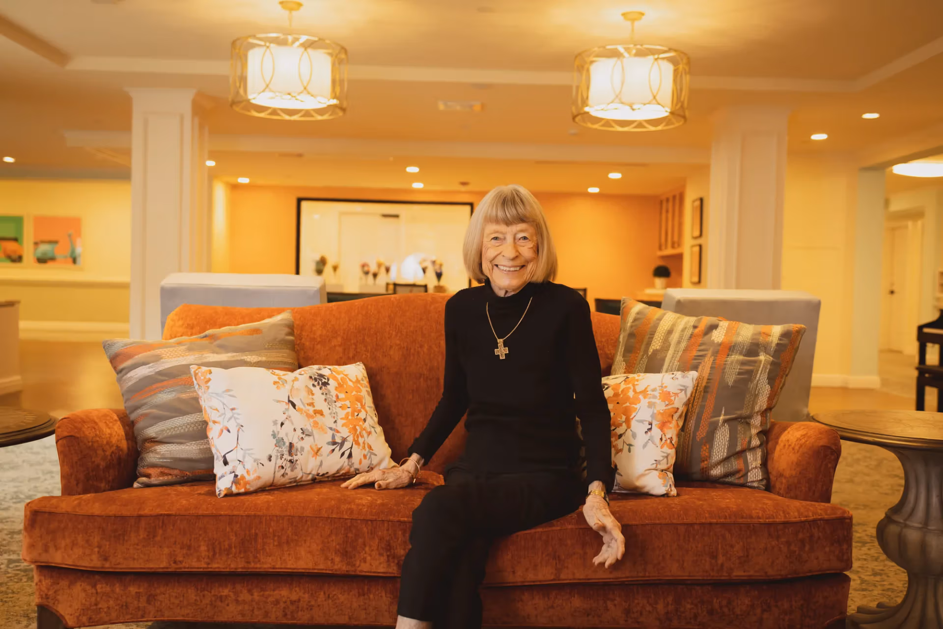 A resident relaxing in a bright, welcoming community lounge