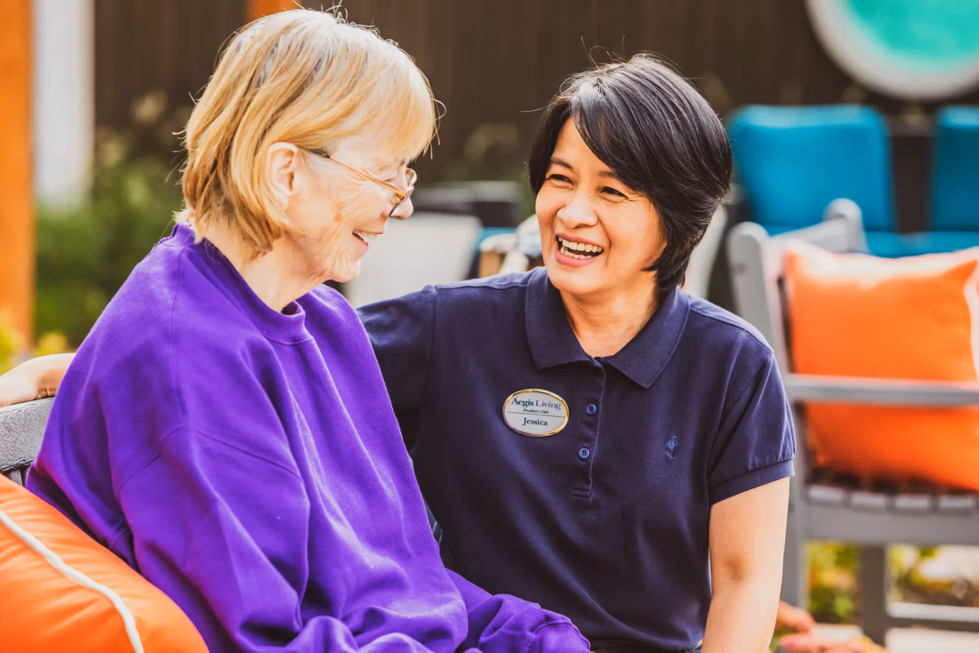 An Áegis Living team member sharing a laugh with a resident — the same team that scales care as needs change.