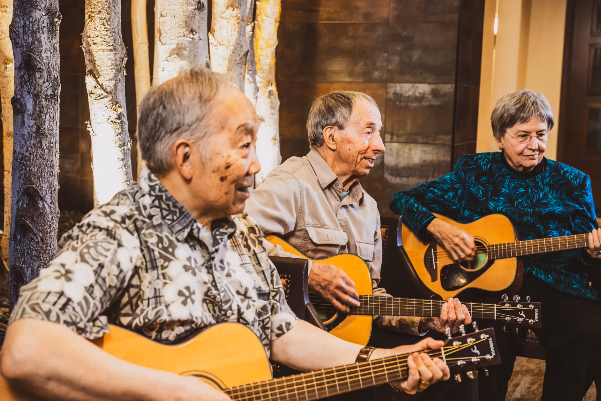 Residents playing guitars together in a live music session