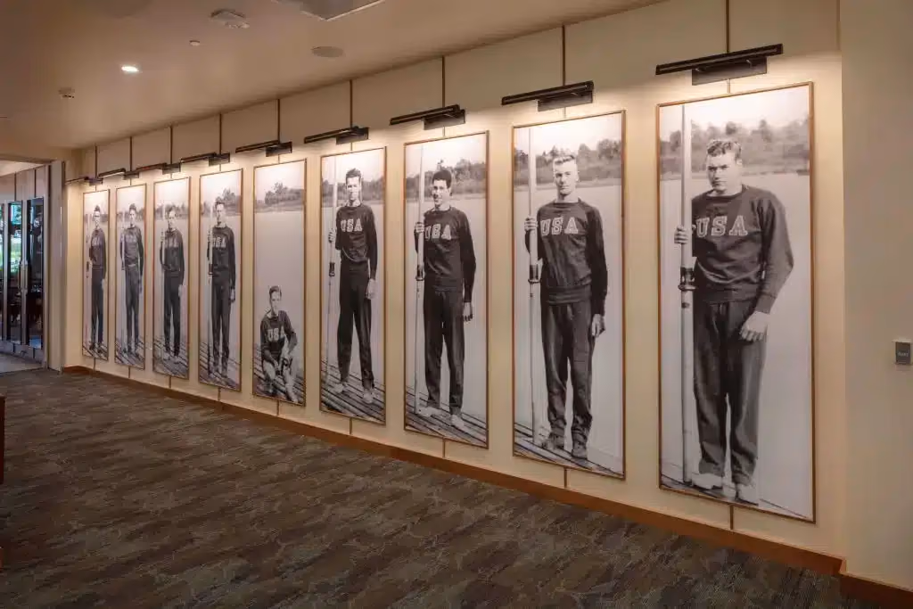 Historic rowing photographs lining a hallway at Áegis Living Lake Union