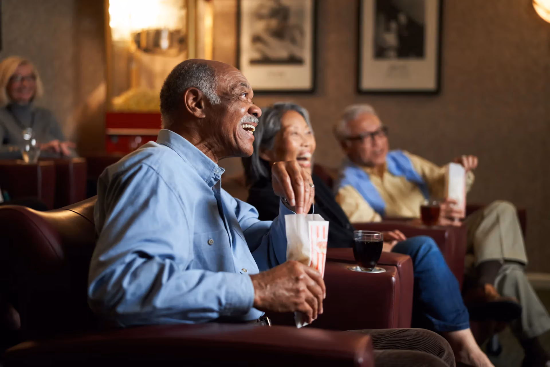 Residents enjoying popcorn at a community movie-theater night