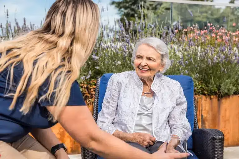Rita G., a resident of Áegis Living West Seattle, smiling outdoors