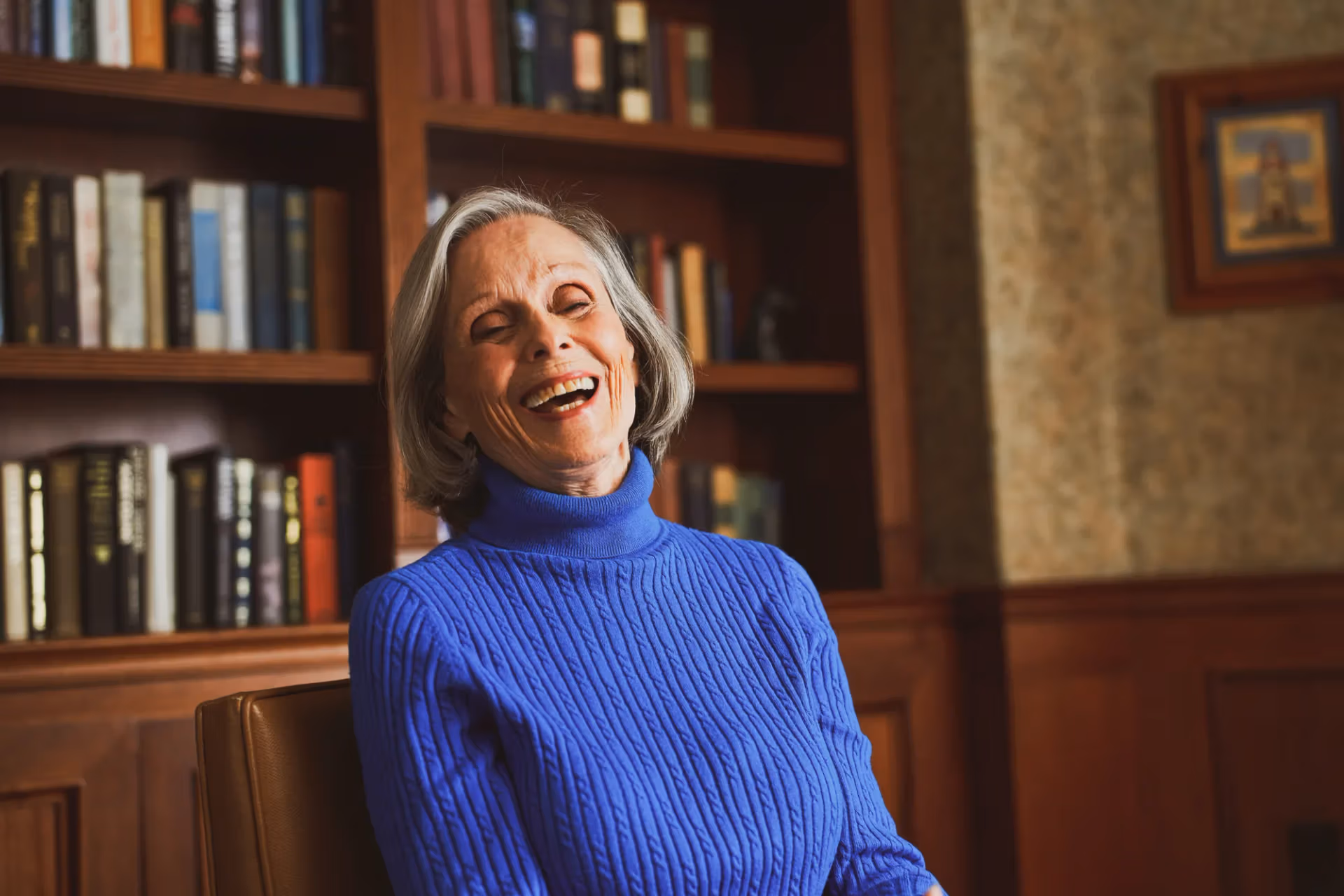 A resident sharing a laugh in the community library