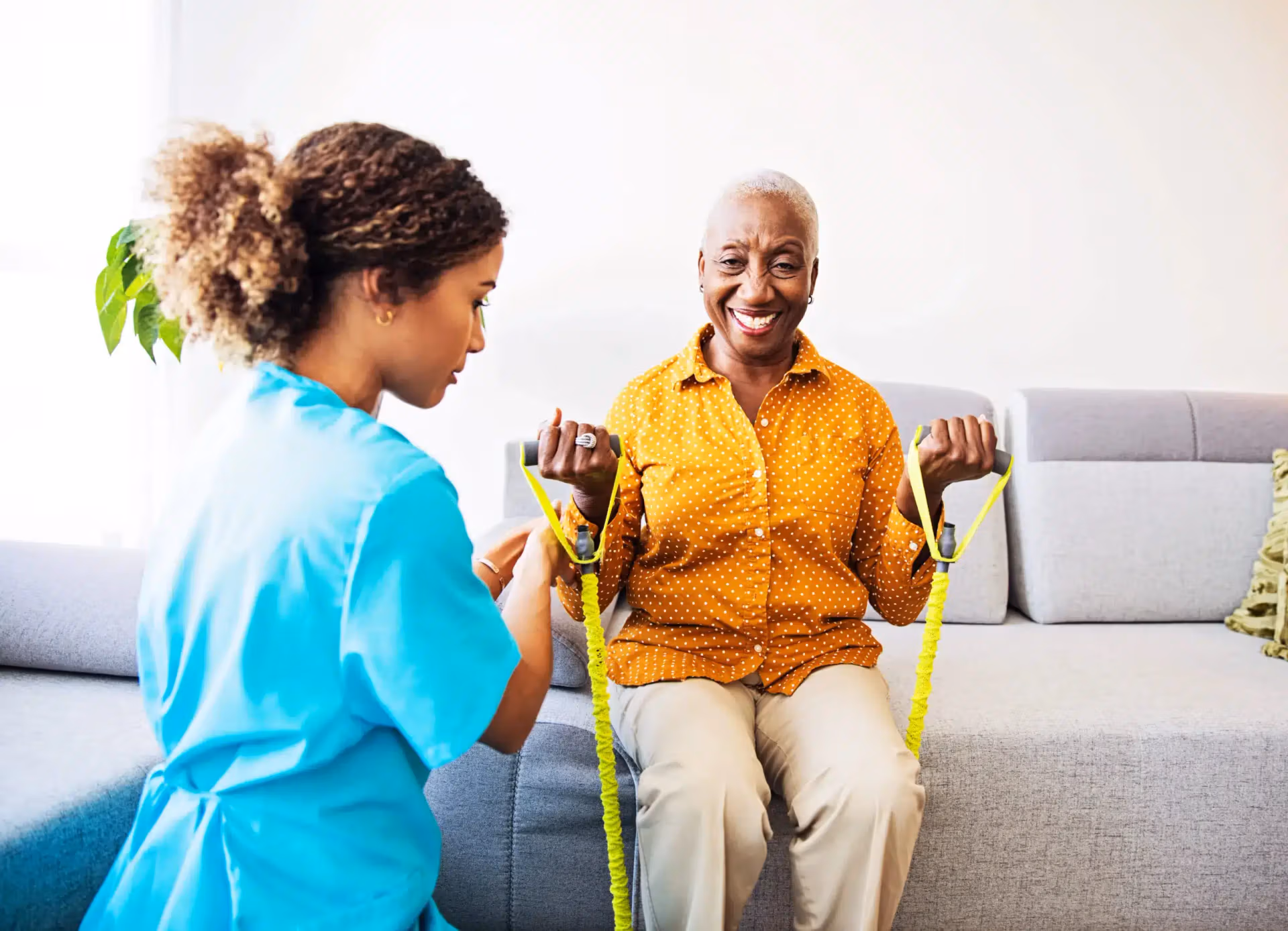 Therapist guiding an Áegis Living resident through a mobility rehabilitation exercise