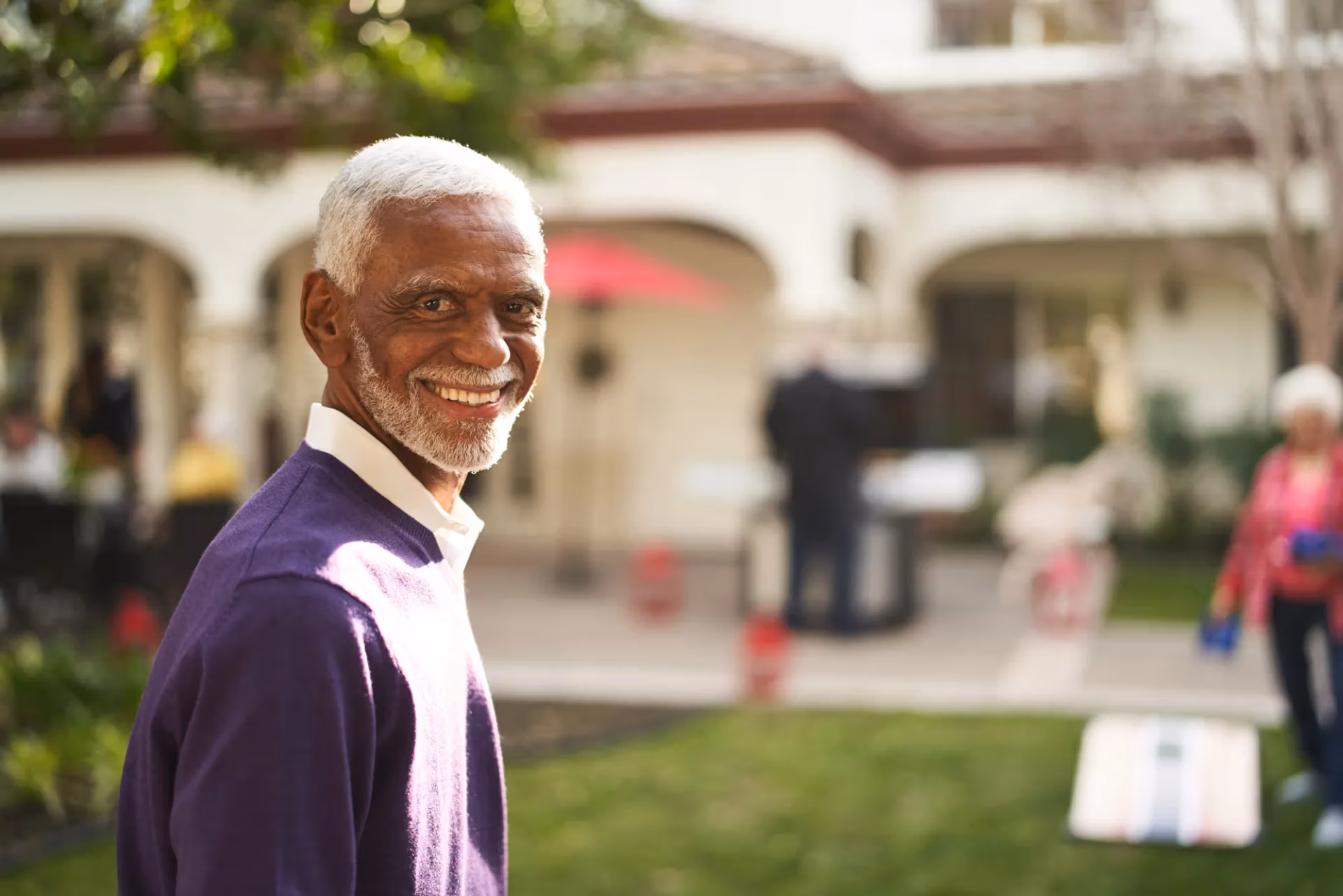 A resident playing lawn games at a community barbecue