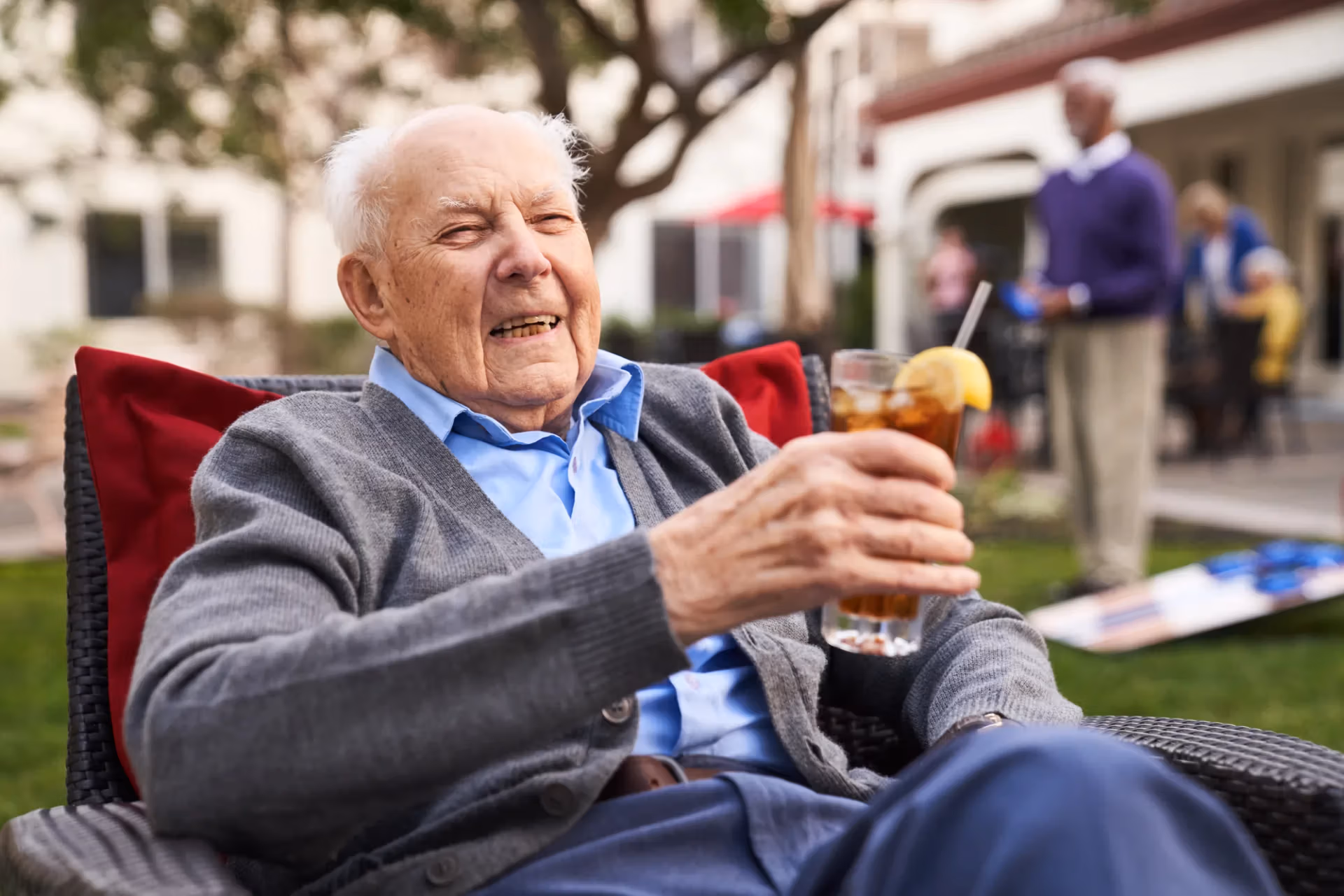 A guest relaxing with an iced tea in a comfortable lounge chair