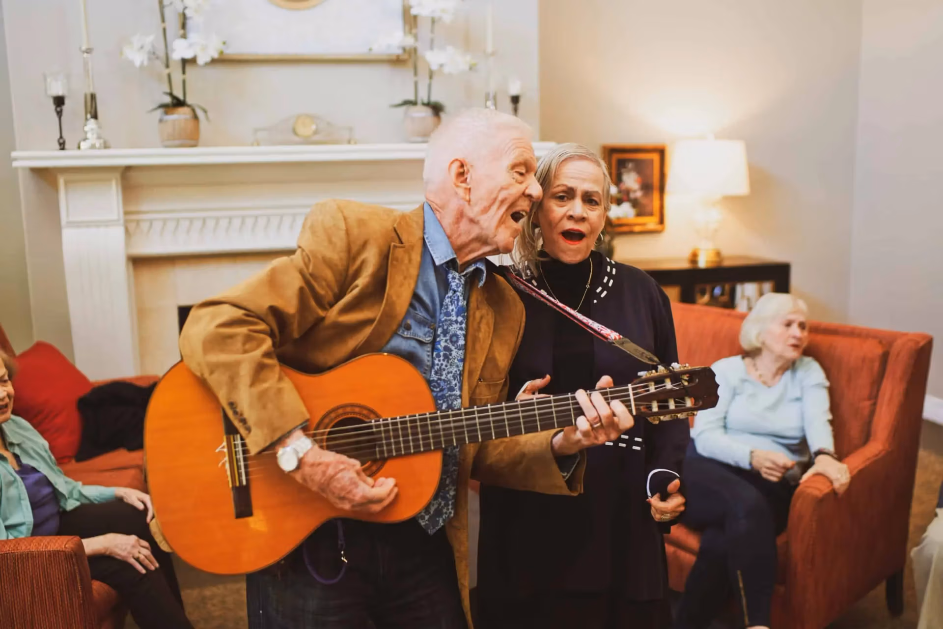 Residents enjoying a live music program at an Áegis Living community