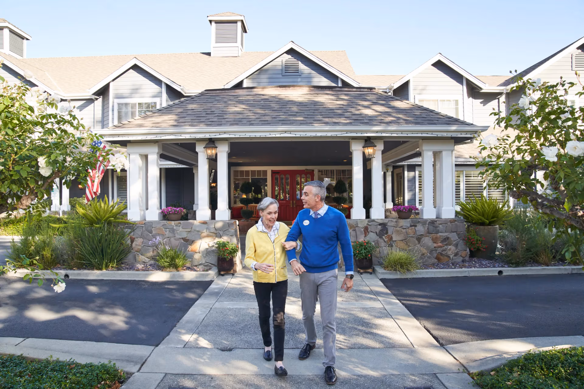 A guest arriving with a team member at the community's covered entrance