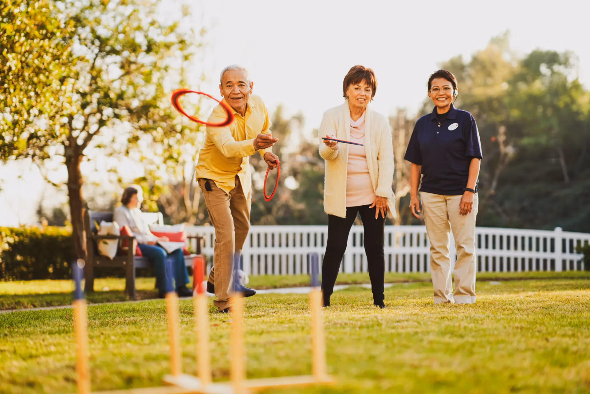 Residents competing in a ring toss match on the community lawn