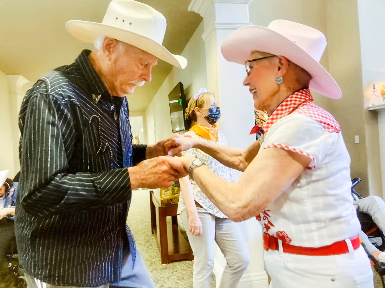 Residents dancing at a western-themed community party