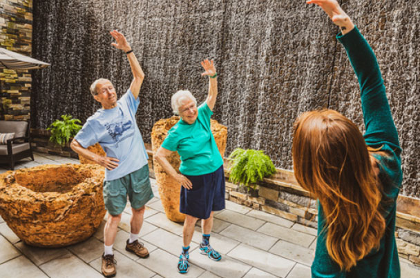 Residents exercising together at an Áegis Living community