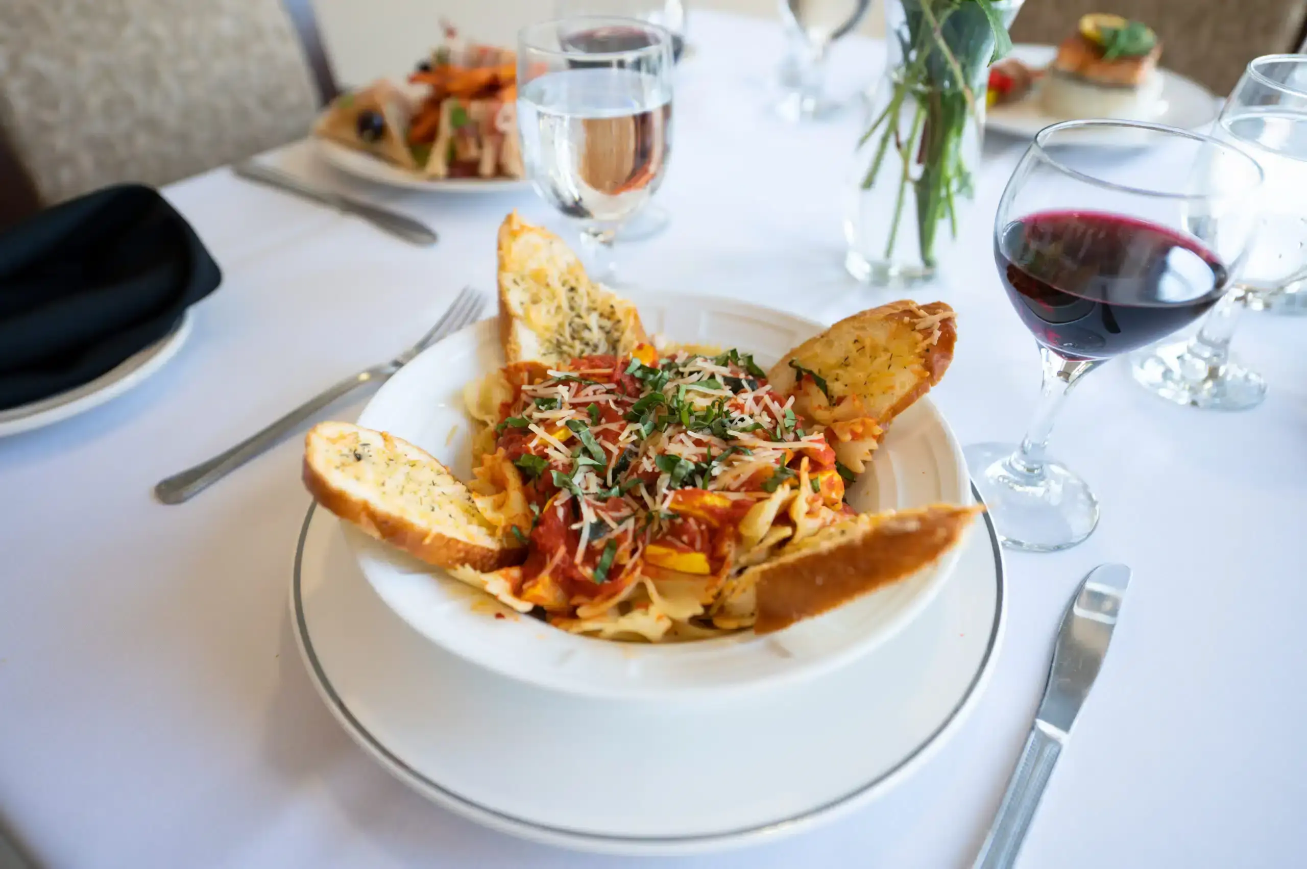 Pasta with garlic bread and wine